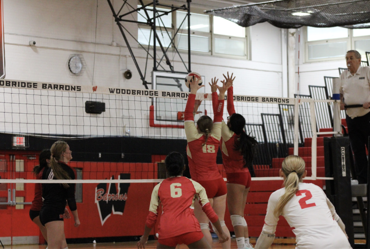 Edison High School’s volleyball team comes up with a big block against Woodbridge.
